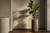Mature fiddle leaf fig in a matte stoneware floor planter against a tadelakt-finish wall, gallery-style Maison Moya interior