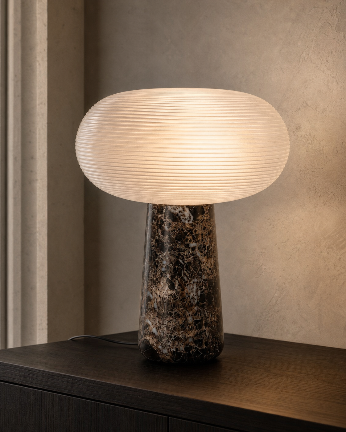 Maison Moya Brioche lamp with ribbed glass and marble base, lit on a dark sideboard