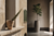 Editorial split composition, a weathered terracotta herb pot on a sun-lit Mediterranean windowsill on the left, a matte stoneware floor planter against a tadelakt wall on the right.